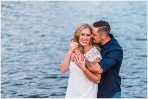 Couple smiling by shores of Indian River Lagoon during Vero Beach engagement
