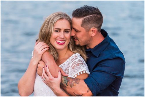 Couple smiling by shores of Indian River Lagoon during Vero Beach engagement