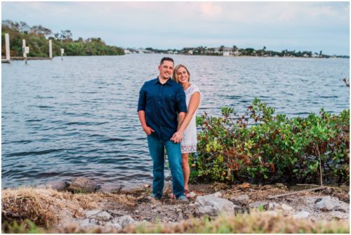 Couple smiling by shores of Indian River Lagoon during Vero Beach engagement
