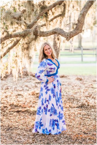 Girl in blue dress under oak trees during Vero Beach engagement