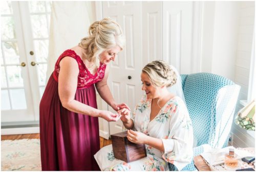 Mom giving bride a gift at Up the Creek Farms Wedding