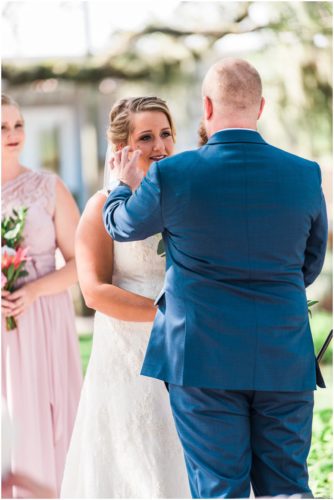 Groom brushing hair away from bride at Up the Creek Farms Wedding