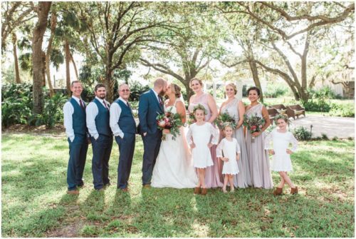 Bridal party with bride and groom kissing at Up the Creek Farms Wedding