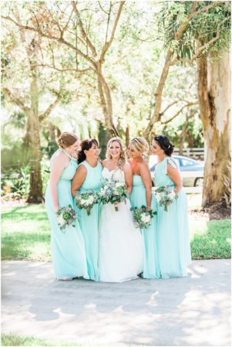 Bride with bridesmaids dressed in mint during beautiful Up the Creek Farms Wedding
