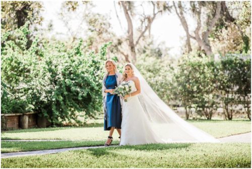 mother walking daughter down aisle during during beautiful Up the Creek Farms Wedding