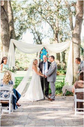 Bride and groom during ceremony during beautiful Up the Creek Farms Wedding