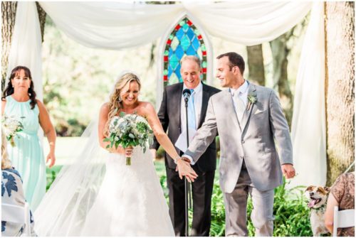 Bride and groom during ceremony during beautiful Up the Creek Farms Wedding
