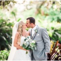 Bride and Groom kissing in foliage during beautiful Up the Creek Farms Wedding