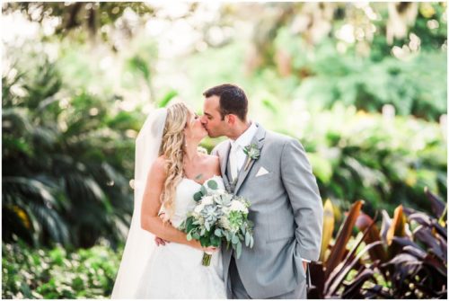 Bride and Groom kissing in foliage during beautiful Up the Creek Farms Wedding