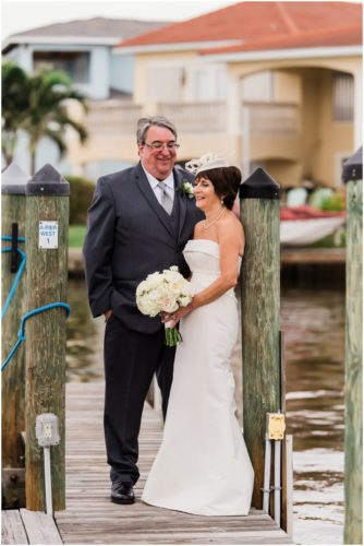 Bride and groom outside by boats Eau Gallie Yacht Club Wedding