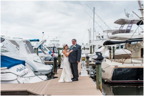 Bride and groom outside by boats Eau Gallie Yacht Club Wedding