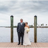 Bride and groom outside by boats Eau Gallie Yacht Club Wedding