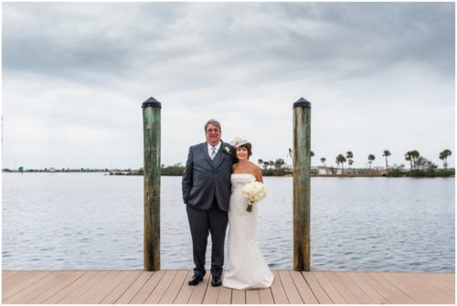 Bride and groom outside by boats Eau Gallie Yacht Club Wedding