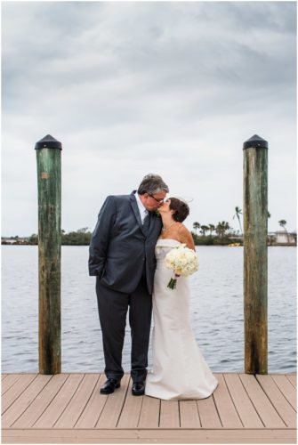 Bride and groom outside by boats Eau Gallie Yacht Club Wedding