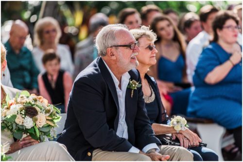 Dad mouthing the vows as his daughter says them during a Up the Creek Farms Wedding