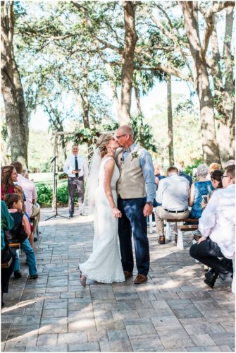 Kising in the middle of the asile during a Up the Creek Farms Wedding