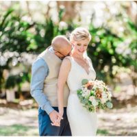 Groom kissing brides neck during a Up the Creek Farms Wedding