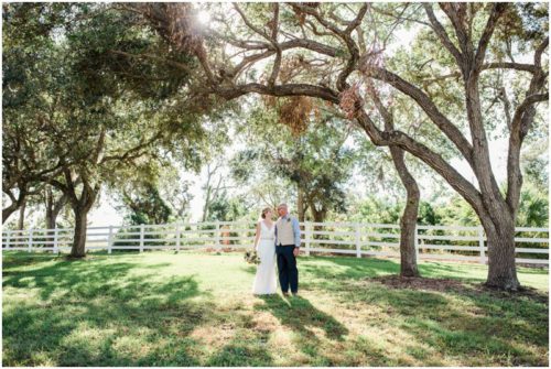 Couple walking under the Oaks during a Up the Creek Farms Wedding