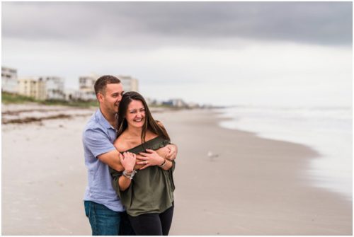 couple laughing on beach during Cocoa Beach Proposal