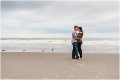 Couple laughing by ocean at Cocoa Beach Proposal