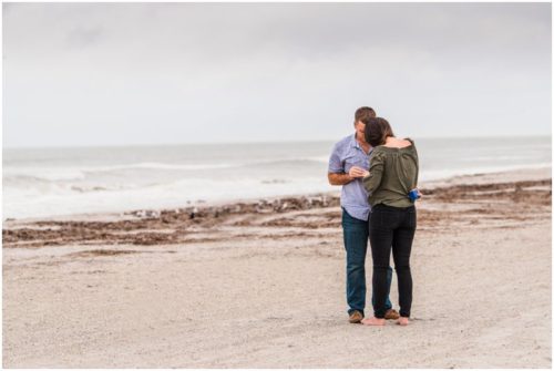 Putting the ring on her finger during Cocoa Beach Proposal