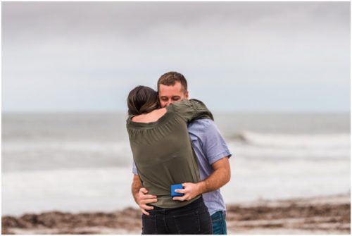 hugging holding the ring box during Cocoa Beach Proposal