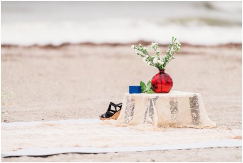 flowers and vintage lace blanket on beach during Cocoa Beach Proposal