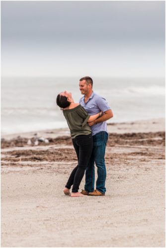 Laughing on beach during Cocoa Beach Proposal