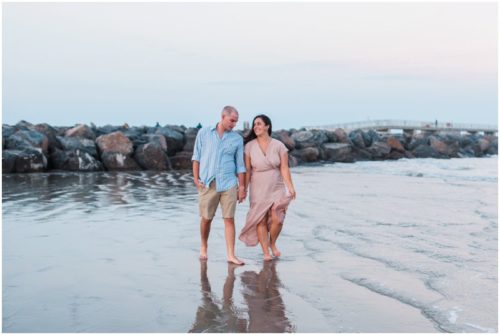 Couple walking on beach at Jetty Park Beach Engagement