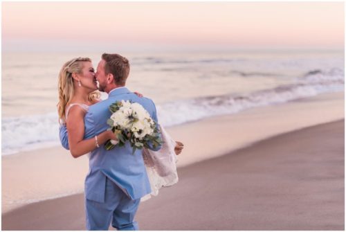 Couple on beach with pink sunset Satellite Beach Wedding