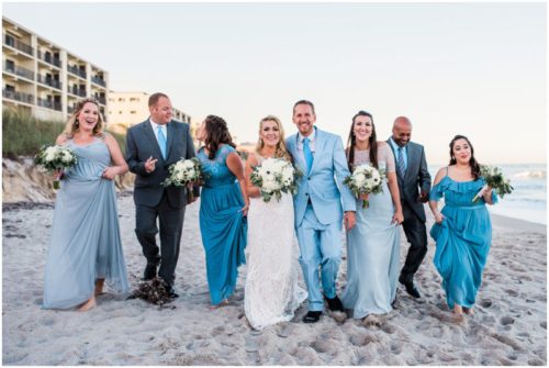 Wedding party walking on beach Satellite Beach Wedding