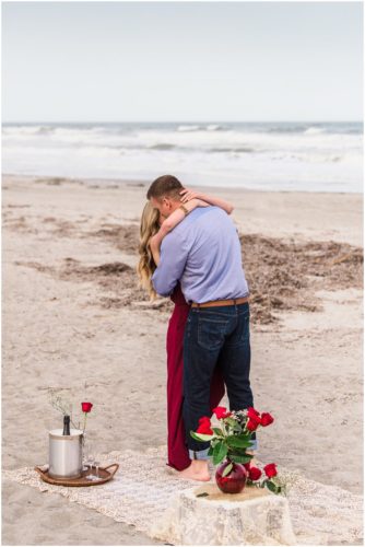 Couple hugging during Cocoa Beach surprise proposal