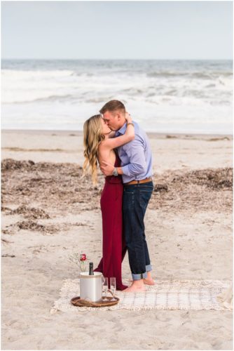 Couple hugging during Cocoa Beach surprise proposal