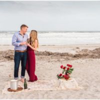 Couple toasting on beach after getting engaged during Cocoa Beach Surprise Proposal