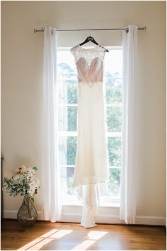 Wedding dress in window during Bellewood Plantation wedding, Vero Beach, Florida