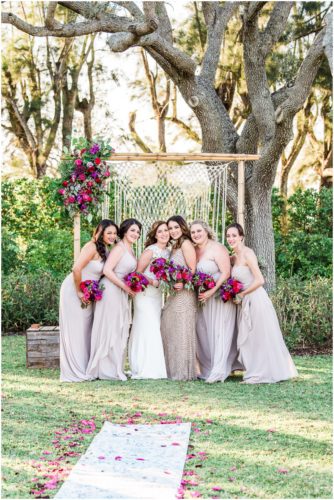 bridal party by arch during Bellewood Plantation wedding, Vero Beach, Florida