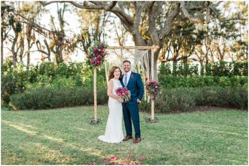 Couple in front of handmade arch during Bellewood Plantation wedding, Vero Beach, Florida