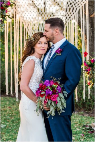 Couple in front of arch during Bellewood Plantation wedding, Vero Beach, Florida