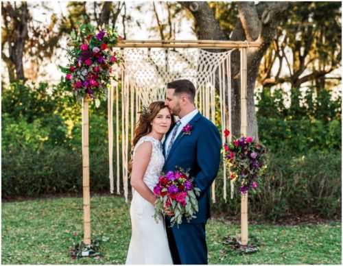 Couple in front of arch during Bellewood Plantation wedding, Vero Beach, Florida