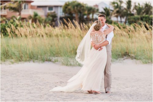 Bride and groom by the sea oats