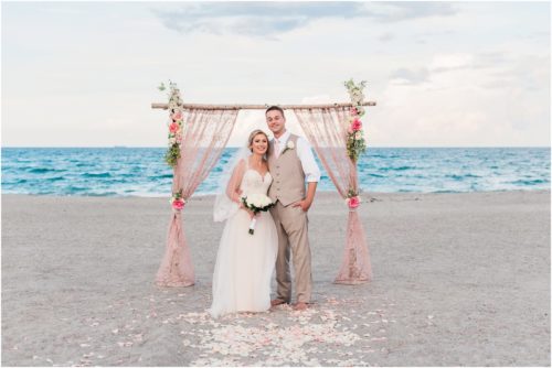 Bride and groom under pink lace arch Cocoa Beach Wedding