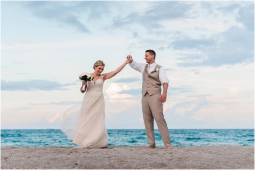 Groom twirling bride on beach Cocoa Beach Wedding