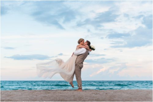 Groom holding bride Cocoa Beach Wedding