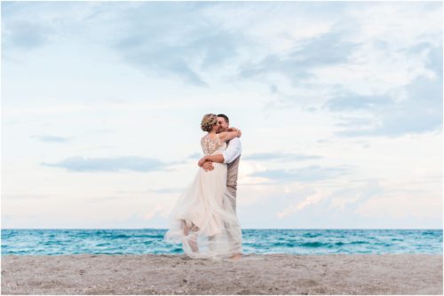Groom spinning bride on beach Cocoa Beach Wedding