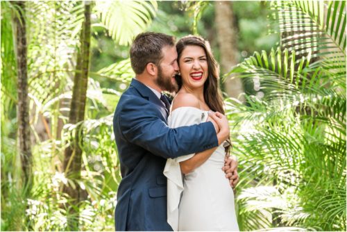 couple laughing by the palm trees at Florida Tech Botanical Gardens Wedding