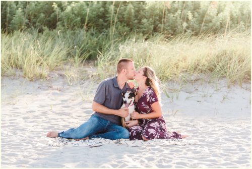 couple sitting on beach with dog Melbourne Florida engagement photographer