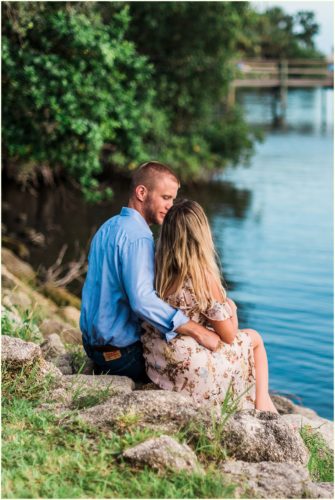Couple sitting on rocks by river Melbourne Florida Engagement Photographer