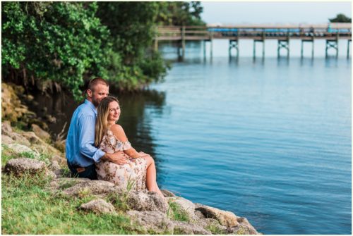 Couple sitting on rocks by river Melbourne Florida Engagement Photographer