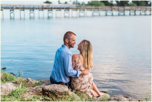 Couple snuggling by water Melbourne Florida Engagement Photographer