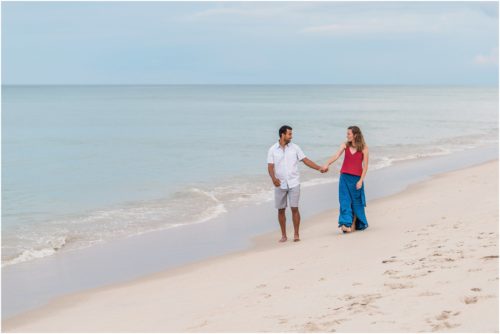Holding hands on the beach after a storm Melbourne Beach Engagement Photography
